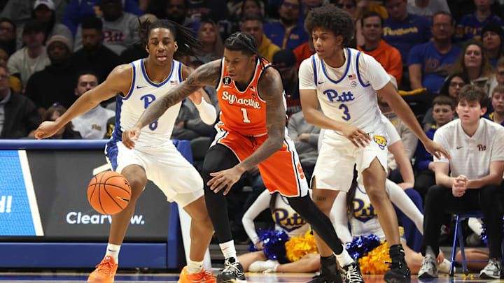 Jan 10, 2026; Pittsburgh, Pennsylvania, USA; Syracuse Orange forward Donnie Freeman (1) grabs a loose ball ahead of Pittsburgh Panthers guard Omari Witherspoon (8) and guard Brandin Cummings (3) during the second half at the Petersen Events Center. Mandatory Credit: Charles LeClaire-Imagn Images