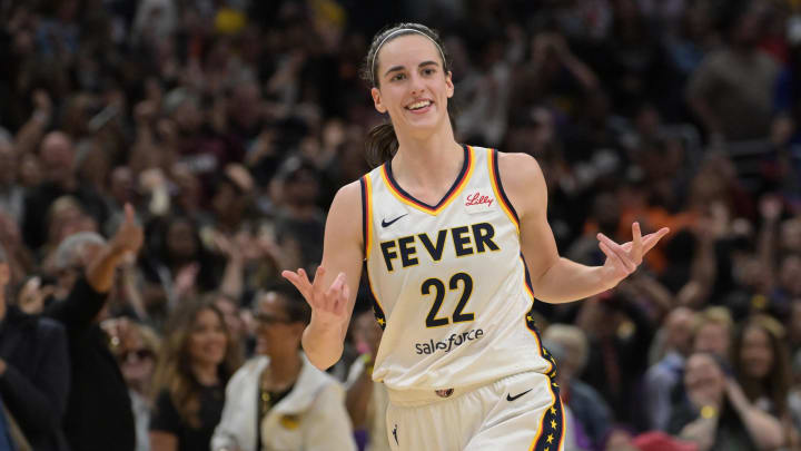 Indiana Fever guard Caitlin Clark (22) smiles as she heads down court after a three  against the Los Angeles Sparks.