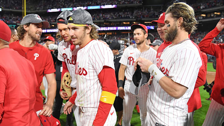 Sep 23, 2024; Philadelphia, Pennsylvania, USA; Philadelphia Phillies pitcher Aaron Nola (27), third base Alec Bohm (28), second baseman Bryson Stott (5), shortstop Trea Turner (7) and first baseman Bryce Harper (3) celebrate after winning the National League East Division with a win against the Chicago Cubs at Citizens Bank Park.