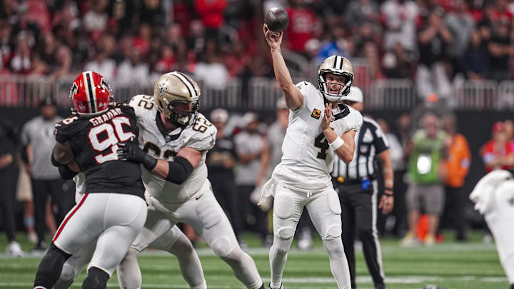 Sep 29, 2024; Atlanta, Georgia, USA; New Orleans Saints quarterback Derek Carr (4) passes the ball against the Atlanta Falcons during the second half at Mercedes-Benz Stadium.