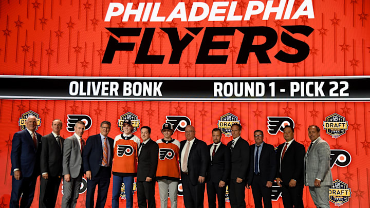 Jun 28, 2023; Nashville, Tennessee, USA; Philadelphia Flyers draft pick Oliver Bonk stands with Flyers staff after being selected with the twenty-second pick in round one of the 2023 NHL Draft at Bridgestone Arena.
