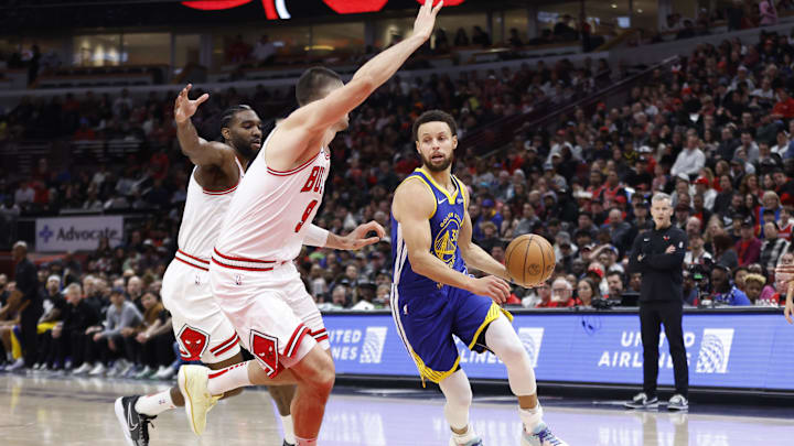 Jan 12, 2024; Chicago, Illinois, USA; Golden State Warriors guard Stephen Curry (30) drives against Chicago Bulls center Nikola Vucevic (9) during the first half at United Center. Mandatory Credit: Kamil Krzaczynski-Imagn Images