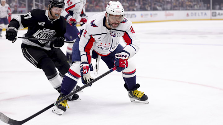 Mar 13, 2025; Los Angeles, California, USA; Washington Capitals left wing Alex Ovechkin (8) and Los Angeles Kings left wing Warren Foegele (37) chase the puck during the first period at Crypto.com Arena. Mandatory Credit: Ryan Sun-Imagn Images