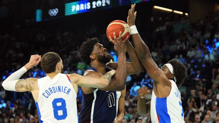 Aug 10, 2024; Paris, France; United States centre Joel Embiid (11) shoots against France power forward Guerschon Yabusele (7) and shooting guard Isaia Cordinier (8) in the second half in the men's basketball gold medal game during the Paris 2024 Olympic Summer Games at Accor Arena. Mandatory Credit: Rob Schumacher-USA TODAY Sports