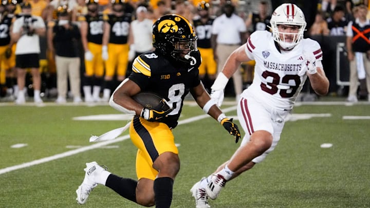 Iowa Hawkeyes running back Terrell Washington Jr. (8) carries the ball as Massachusetts Minutemen defensive lineman Erik Hehl (33) defends Sept. 13, 2025 at Kinnick Stadium in Iowa City, Iowa.