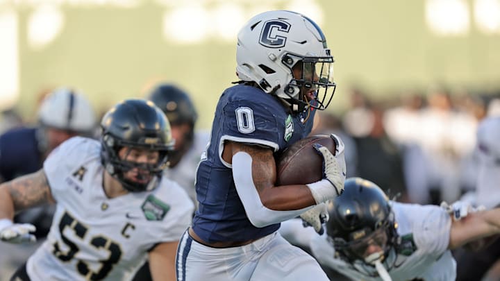 UConn running back Cam Edwards (0) runs the ball against the Army Black Knights during the first half of the Wasabi Fenway Bowl