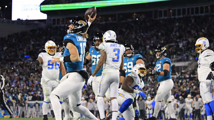 Jacksonville Jaguars quarterback Trevor Lawrence (16) spikes the ball after scoring a two point