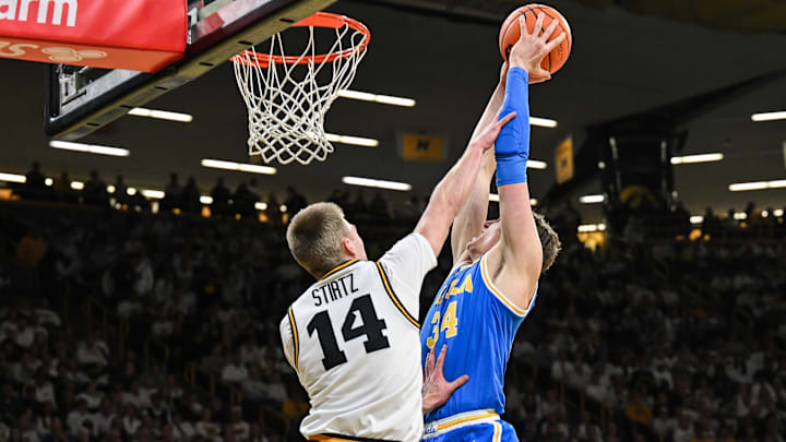 UCLA Bruins forward Tyler Bilodeau (34) goes to the basket as Iowa Hawkeyes guard Bennett Stirtz (14) defends
