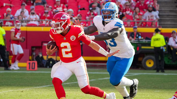 Aug 17, 2024; Kansas City, Missouri, USA; Kansas City Chiefs quarterback Ian Book (2) drops back to pass as Detroit Lions defensive end Josh Paschal (93) chases during the game at GEHA Field at Arrowhead Stadium. Mandatory Credit: Denny Medley-Imagn Images