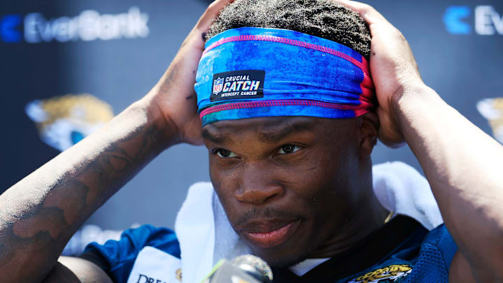 Jacksonville Jaguars wide receiver Travis Hunter (12) adjusts his headband before speaking to members of the media during the second mandatory minicamp at Miller Electric Center Wednesday, June 11, 2025 in Jacksonville, Fla.