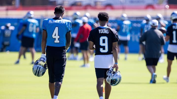 Jul 26, 2025; Charlotte, NC, USA; Carolina Panthers wide receiver Tetairoa McMillan (4) and quarterback Bryce Young (9) talk as they head to stretch during training camp. Mandatory Credit: Scott Kinser-Imagn Images