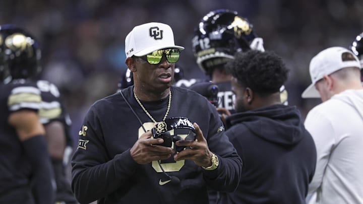 Dec 28, 2024; San Antonio, TX, USA; Colorado Buffaloes head coach Deion Sanders walks on the field between plays during the first quarter against the Brigham Young Cougars at Alamodome. Mandatory Credit: Troy Taormina-Imagn Images