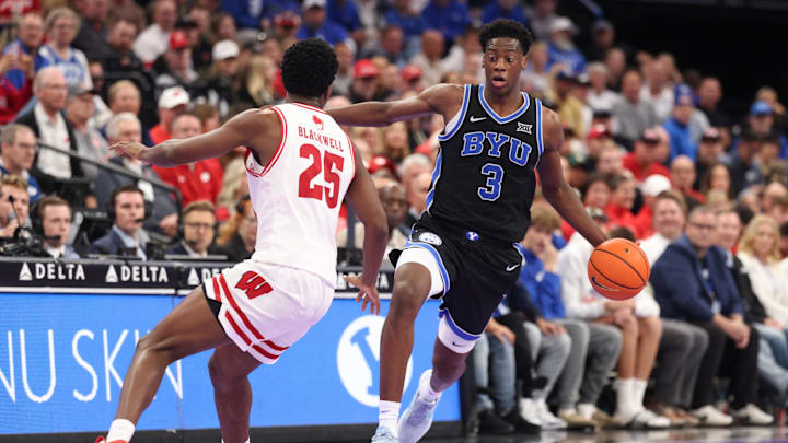 Nov 21, 2025; Salt Lake City, Utah, USA; BYU Cougars forward AJ Dybantsa (3) brings the ball up the courts against Wisconsin Badgers guard John Blackwell (25) during the second half at Delta Center. Mandatory Credit: Rob Gray-Imagn Images