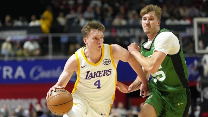 Los Angeles Lakers forward Dalton Knecht (4) drives the ball against Boston Celtics guard Baylor Scheierman (55). Los Angeles Lakers forward Dalton Knecht (4) drives the ball against Boston Celtics guard Baylor Scheierman (55).