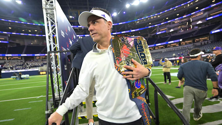 Dec 13, 2025; Inglewood, CA, USA; Washington Huskies head coach Jedd Fisch holds the LA Bowl championship belt after defeating the Boise State Broncos at SoFi Stadium. Mandatory Credit: Jayne Kamin-Oncea-Imagn Images Dec 13, 2025; Inglewood, CA, USA; Washington Huskies head coach Jedd Fisch holds the LA Bowl championship belt after defeating the Boise State Broncos at SoFi Stadium. Mandatory Credit: Jayne Kamin-Oncea-Imagn Images