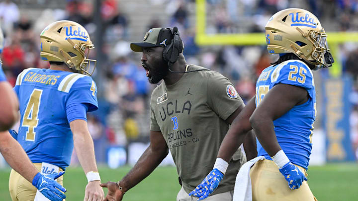Nov 30, 2024; Pasadena, California, USA; UCLA Bruins head coach DeShaun Foster greets quarterback Ethan Garbers (4) during the third quarter against the Fresno State Bulldogs at Rose Bowl. Mandatory Credit: Robert Hanashiro-Imagn Images