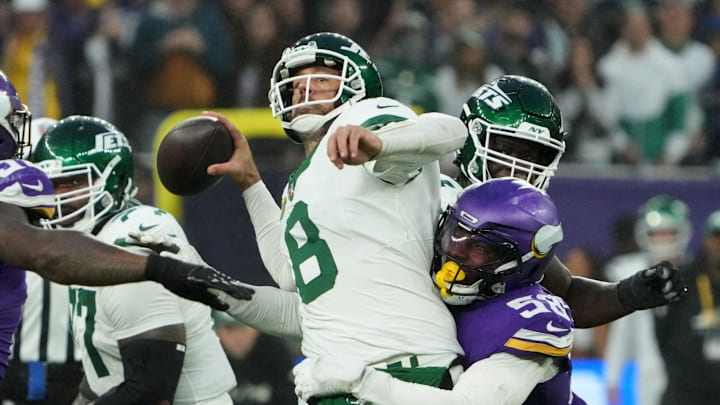 Oct 6, 2024; London, United Kingdom; New York Jets quarterback Aaron Rodgers (8) throws the ball under pressure from Minnesota Vikings linebacker Jonathan Greenard (58) in the fourth quarter at Tottenham Hotspur Stadium. Mandatory Credit: Kirby Lee-Imagn Images