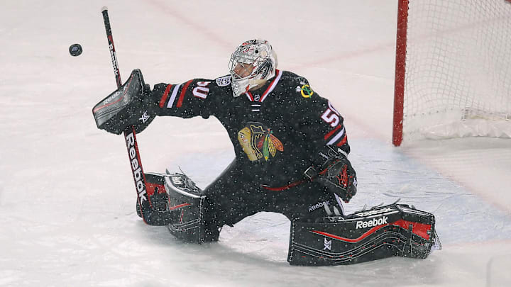 Mar 1, 2014; Chicago, IL, USA; Chicago Blackhawks goalie Corey Crawford (50) makes a save during the third period against the Pittsburgh Penguins in a Stadium Series hockey game at Soldier Field. Chicago won 5-1. Mandatory Credit: Dennis Wierzbicki-Imagn Images Mar 1, 2014; Chicago, IL, USA; Chicago Blackhawks goalie Corey Crawford (50) makes a save during the third period against the Pittsburgh Penguins in a Stadium Series hockey game at Soldier Field. Chicago won 5-1. Mandatory Credit: Dennis Wierzbicki-Imagn Images