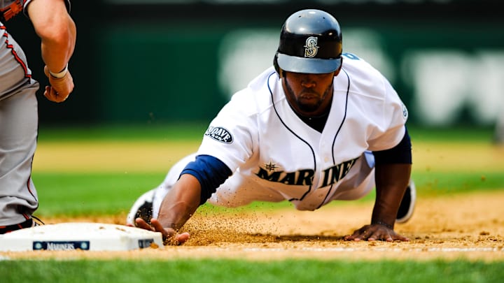 Seattle Mariners right fielder Carlos Peguero (8) slides back to first base during the game against the Baltimore Orioles at Safeco Field. Seattle beat Baltimore 4-3 in 2011.