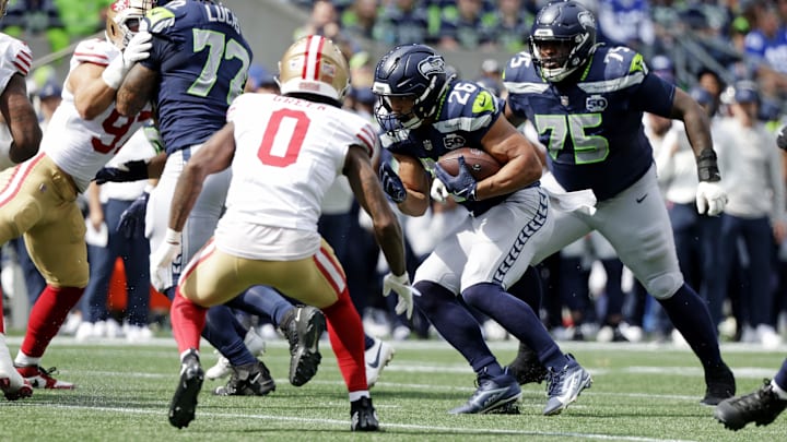Sep 7, 2025; Seattle, Washington, USA; Seattle Seahawks running back Zach Charbonnet (26) runs the ball during the first half against San Francisco 49ers during the first quarter at Lumen Field. Mandatory Credit: Joe Nicholson-Imagn Images