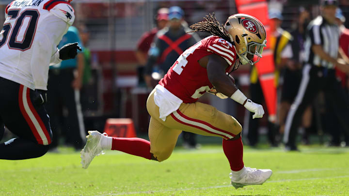 Sep 29, 2024; Santa Clara, California, USA; San Francisco 49ers running back Jordan Mason (24) runs with the ball past New England Patriots linebacker Raekwon McMillan (50) during the third quarter at Levi's Stadium. Mandatory Credit: Sergio Estrada-Imagn Images