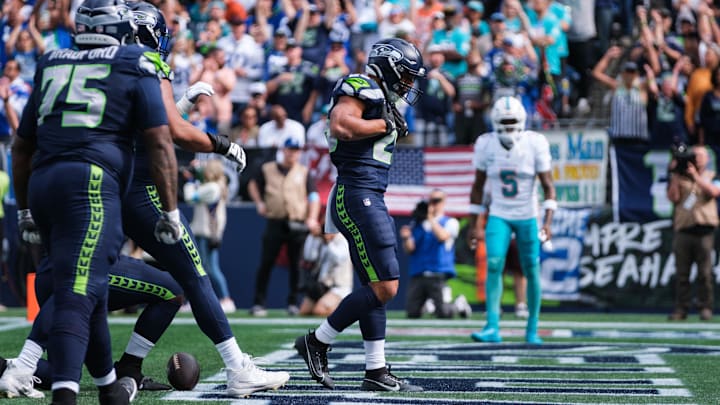 Seattle Seahawks running back Zach Charbonnet (26) celebrates after scoring a touchdown in the first quarter against Miami Dolphins at Lumen Field.