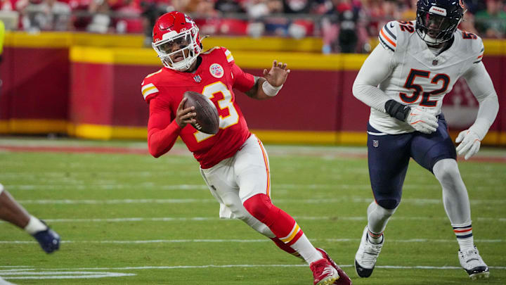 Aug 22, 2024; Kansas City, Missouri, USA; Kansas City Chiefs quarterback Chris Oladokun (13) scrambles as Chicago Bears defensive end Khalid Kareem (52) chases during the first half at GEHA Field at Arrowhead Stadium. Mandatory Credit: Denny Medley-Imagn Images
