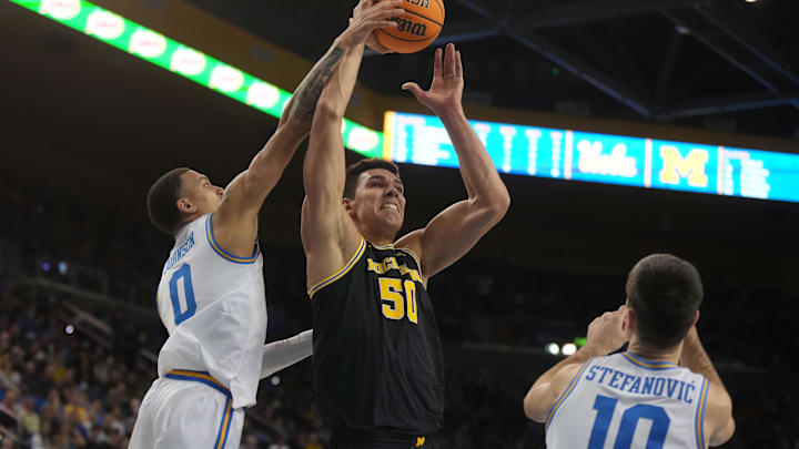 Jan 7, 2025; Los Angeles, California, USA; Michigan Wolverines center Vladislav Goldin (50) shoots the ball against UCLA Bruins guard Kobe Johnson (0) and guard Lazar Stefanovic (10) in the first half at Pauley Pavilion presented by Wescom. Mandatory Credit: Kirby Lee-Imagn Images Jan 7, 2025; Los Angeles, California, USA; Michigan Wolverines center Vladislav Goldin (50) shoots the ball against UCLA Bruins guard Kobe Johnson (0) and guard Lazar Stefanovic (10) in the first half at Pauley Pavilion presented by Wescom. Mandatory Credit: Kirby Lee-Imagn Images