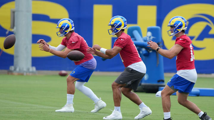 Jun 3, 2025; Woodland Hills, CA, USA; Los Angeles Rams quarterbacks Matthew Stafford (left), Jimmy Garoppolo (center) and Stetson Bennett take the snap during organized team activities at Rams Practice Facility. Mandatory Credit: Kirby Lee-Imagn Images Jun 3, 2025; Woodland Hills, CA, USA; Los Angeles Rams quarterbacks Matthew Stafford (left), Jimmy Garoppolo (center) and Stetson Bennett take the snap during organized team activities at Rams Practice Facility. Mandatory Credit: Kirby Lee-Imagn Images