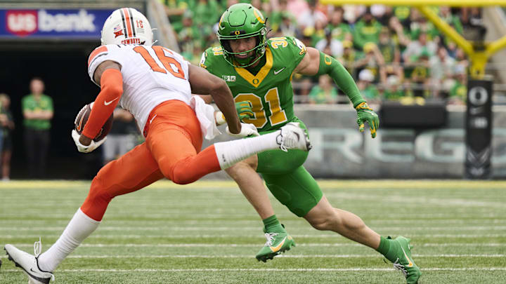 Safety Dillon Thieneman closes in on Oklahoma State receiver Christian Fitzpatrick. Thieneman's impressive combine could make him a draft target of teams needing safeties, like the Bears.