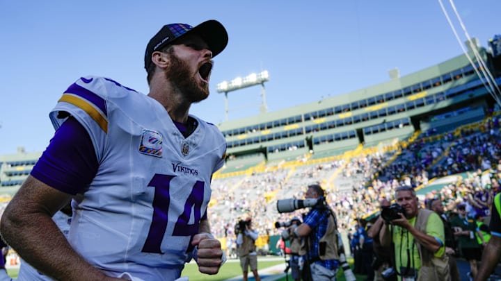 Sep 29, 2024; Green Bay, Wisconsin, USA;  Minnesota Vikings quarterback Sam Darnold (14) cheers as he leaves the field following the game against the Green Bay Packers at Lambeau Field.