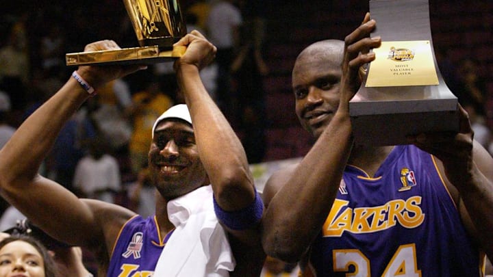 June 12, 2002; East Rutherford, NJ; The Los Angeles Lakers' Kobe Bryant holds up the Larry O'Brien championship trophy along with teammate Shaquille O'Neal who holds up his third MVP trophy. Mandatory Credit:  Michael J. Terola/Abury Park Press-USA TODAY NETWORK 