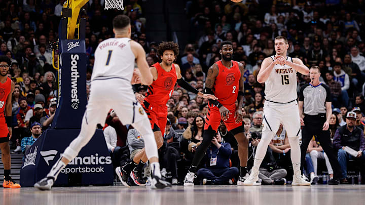 Feb 4, 2024; Denver, Colorado, USA; Denver Nuggets center Nikola Jokic (15) passes the ball to forward Michael Porter Jr. (1) as Portland Trail Blazers guard Matisse Thybulle (4) and center Deandre Ayton (2) defend in the third quarter at Ball Arena. Mandatory Credit: Isaiah J. Downing-Imagn Images