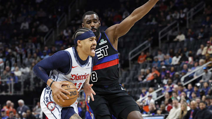 Mar 13, 2025; Detroit, Michigan, USA;  Washington Wizards guard Jordan Poole (13) is defended by Detroit Pistons forward Tim Hardaway Jr. (8) in the first half at Little Caesars Arena. Mandatory Credit: Rick Osentoski-Imagn Images