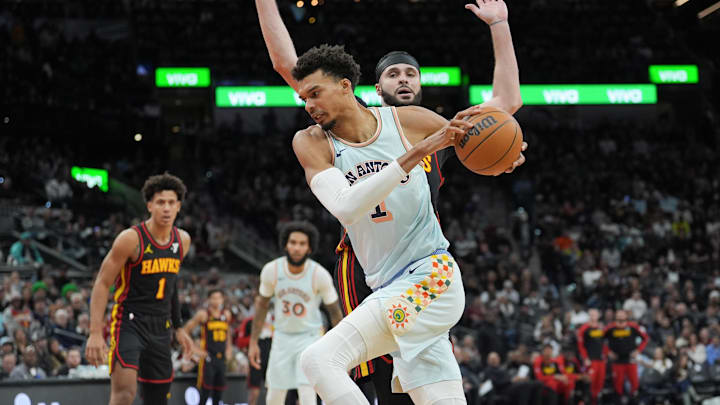 Dec 19, 2024; San Antonio, Texas, USA; San Antonio Spurs center Victor Wembanyama (1) goes past Atlanta Hawks forward Larry Nance Jr. (22) in the first half at Frost Bank Center.