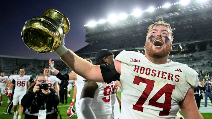 Indiana Hoosiers offensive lineman Bray Lynch (74) holds up The Old Brass Spittoon after beating Michigan State at Spartan Stadium. Mandatory Credit: Dale Young-Imagn Images Indiana Hoosiers offensive lineman Bray Lynch (74) holds up The Old Brass Spittoon after beating Michigan State at Spartan Stadium. Mandatory Credit: Dale Young-Imagn Images