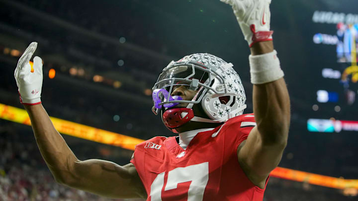 Ohio State Buckeyes wide receiver Carnell Tate (17) celebrates a touchdown Saturday, Dec. 6, 2025, during the Big Ten football championship against the Indiana Hoosiers at Lucas Oil Stadium in Indianapolis.
