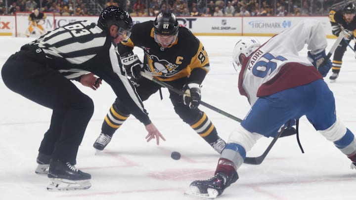 Mar 24, 2026; Pittsburgh, Pennsylvania, USA;  Pittsburgh Penguins center Sidney Crosby (87) and Colorado Avalanche center Nazem Kadri (91) take a first period face-off at PPG Paints Arena. Mandatory Credit: Charles LeClaire-Imagn Images