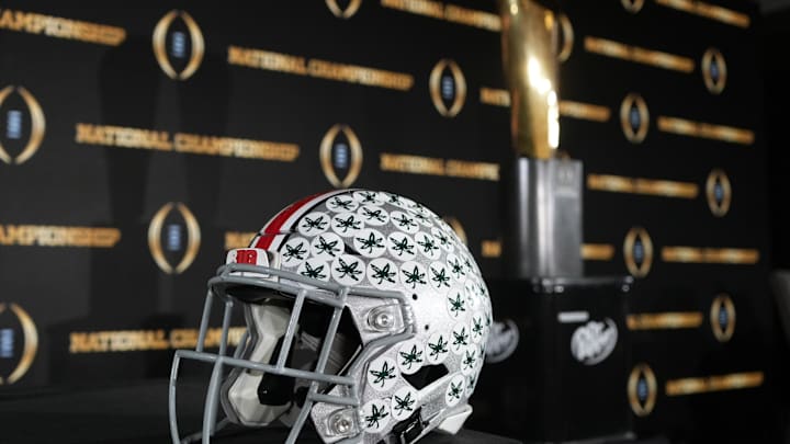 Jan 19, 2025; Atlanta, GA, USA; An Ohio State Buckeyes helmet and College Football Playoff National Championship trophy at press conference at The Westin Peachtree Plaza, Savannah Ballroom. Mandatory Credit: Kirby Lee-Imagn Images Jan 19, 2025; Atlanta, GA, USA; An Ohio State Buckeyes helmet and College Football Playoff National Championship trophy at press conference at The Westin Peachtree Plaza, Savannah Ballroom. Mandatory Credit: Kirby Lee-Imagn Images