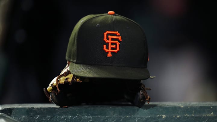 General view of a San Francisco Giants cap and glove during the ninth inning against the Colorado Rockies at Coors Field.
