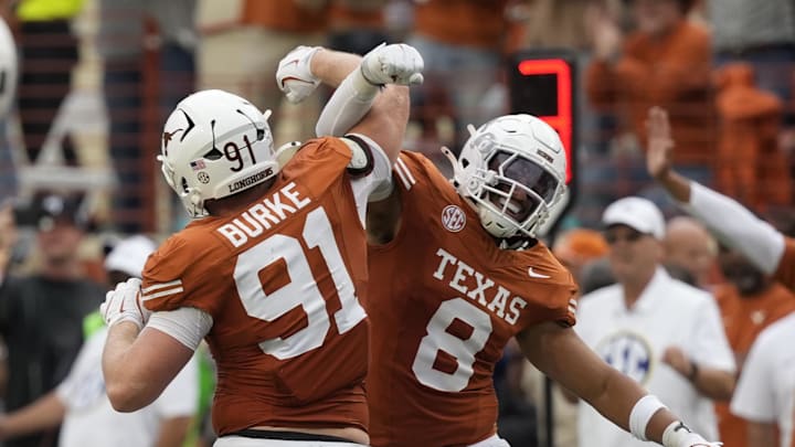 Texas Longhorns linebacker Trey Moore and defensive lineman Ethan Burke react to a defensive stop during the second half against the Vanderbilt Commodores Darrell K Royal-Texas Memorial Stadium.