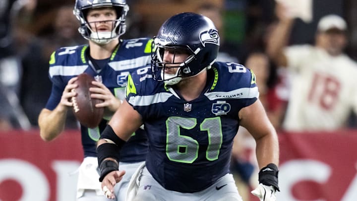 Sep 25, 2025; Glendale, Arizona, USA; Seattle Seahawks center Jalen Sundell (61) blocks for quarterback Sam Darnold (14) against the Arizona Cardinals at State Farm Stadium. Mandatory Credit: Mark J. Rebilas-Imagn Images Sep 25, 2025; Glendale, Arizona, USA; Seattle Seahawks center Jalen Sundell (61) blocks for quarterback Sam Darnold (14) against the Arizona Cardinals at State Farm Stadium. Mandatory Credit: Mark J. Rebilas-Imagn Images