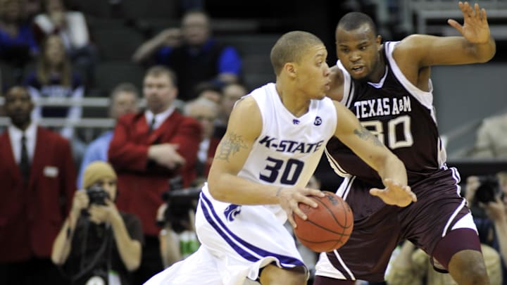 March 14, 2008; Kansas City, MO, USA; Kansas State Wildcats forward Michael Beasley (30) drives against Texas A&M Aggies forward Joseph Jones (30) in the second half during the 2008 Big Twelve Mens Basketball Tournament at the Sprint Center. Texas A&M defeated Kansas State 63-60. Mandatory Credit: Peter G. Aiken-Imagn Images