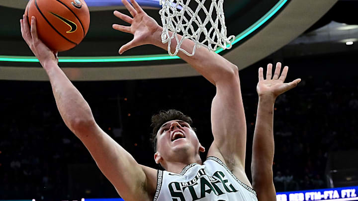 Dec 21, 2024; East Lansing, Michigan, USA;  Michigan State Spartans center Szymon Zapala (10) puts up a shot past Florida Atlantic Owls forward Baba Miller (18) during the second half at Jack Breslin Student Events Center. Mandatory Credit: Dale Young-Imagn Images