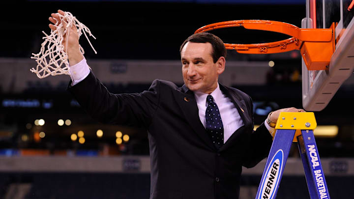 Duke head coach Mike Krzyzewski cuts down the nets at the 2010 NCAA men's Final Four national basketball championship after Duke beat Butler 61-59.