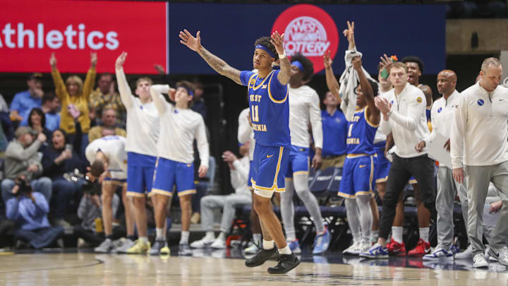 Jan 18, 2025; Morgantown, West Virginia, USA; West Virginia Mountaineers guard Jonathan Powell (11) celebrates after a made three-point basket during the second half against the Iowa State Cyclones at WVU Coliseum. Mandatory Credit: Ben Queen-Imagn Images