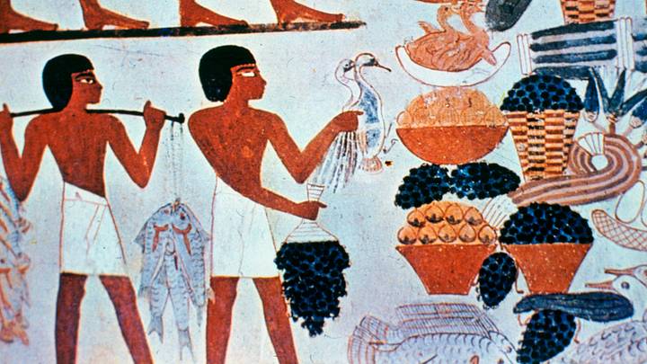 Ancient Egyptian wall paintings in a tomb at Thebes, Egypt.