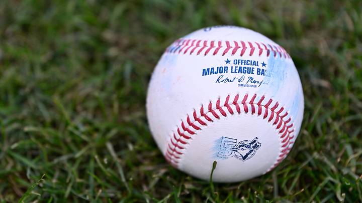 Jul 24, 2026; Boston, Massachusetts, USA; An official MLB baseball with a Toronto Blue Jays logo sits on the grass before a game against the Boston Red Sox at Fenway Park. Mandatory Credit: Eric Canha-Imagn Images