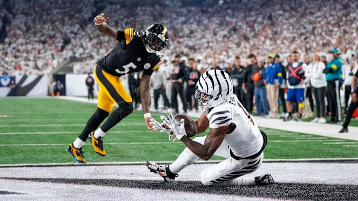 Cincinnati Bengals wide receiver Ja'Marr Chase (1) catches a pass under pressure from Pittsburgh Steelers cornerback Jalen Ramsey (5) for a touchdown in the second quarter of the NFL Week 7 game between the Cincinnati Bengals and the Pittsburgh Steelers at Paycor Stadium in downtown Cincinnati on Thursday, Oct. 16, 2025.