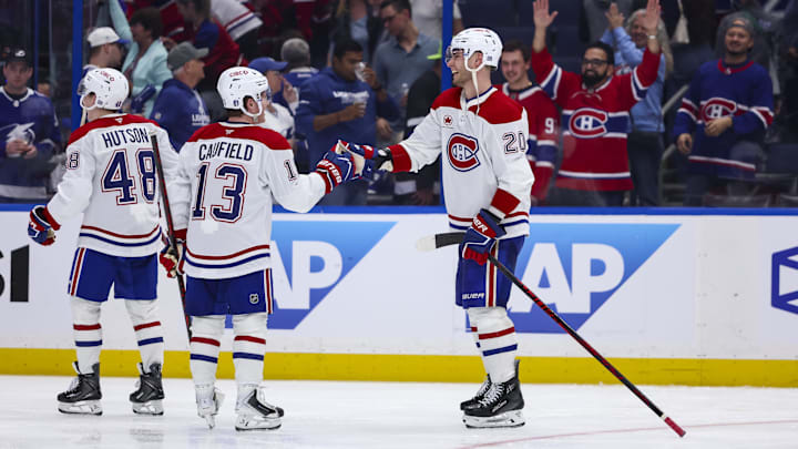 Apr 19, 2026; Tampa, Florida, USA; Montreal Canadiens forward Juraj Slafkovsky (20) celebrates the win with forward Cole Caufield (13) against the Tampa Bay Lightning during extra time in game one of the first round of the 2026 Stanley Cup Playoffs at Benchmark International Arena. Mandatory Credit: Morgan Tencza-Imagn Images